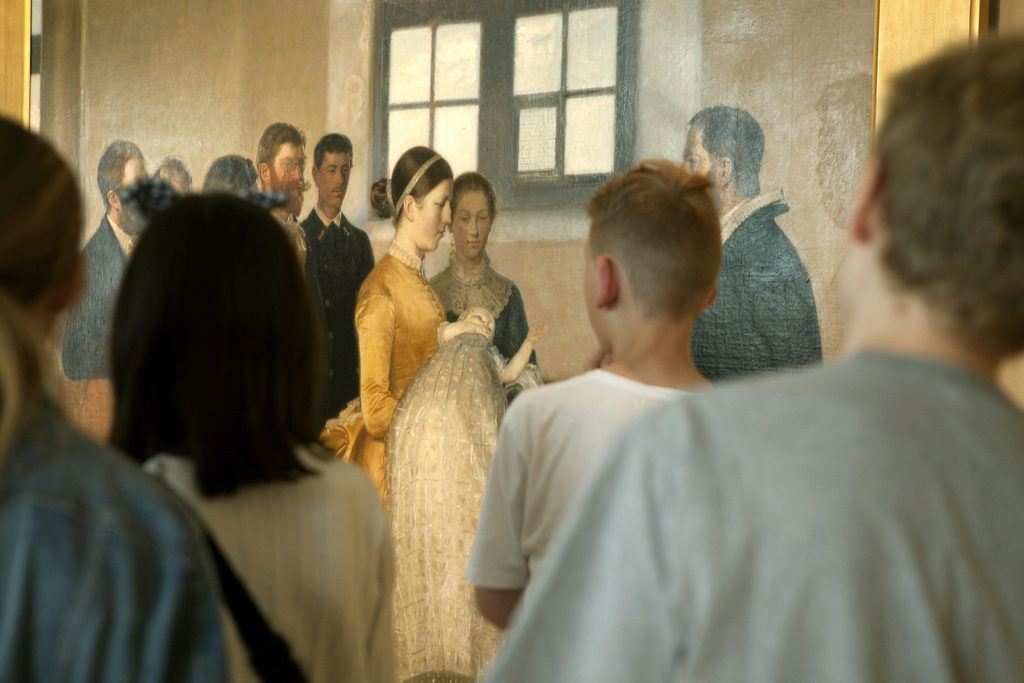 School children in front of "A Christening" made by Michael Ancher in 1883-1888